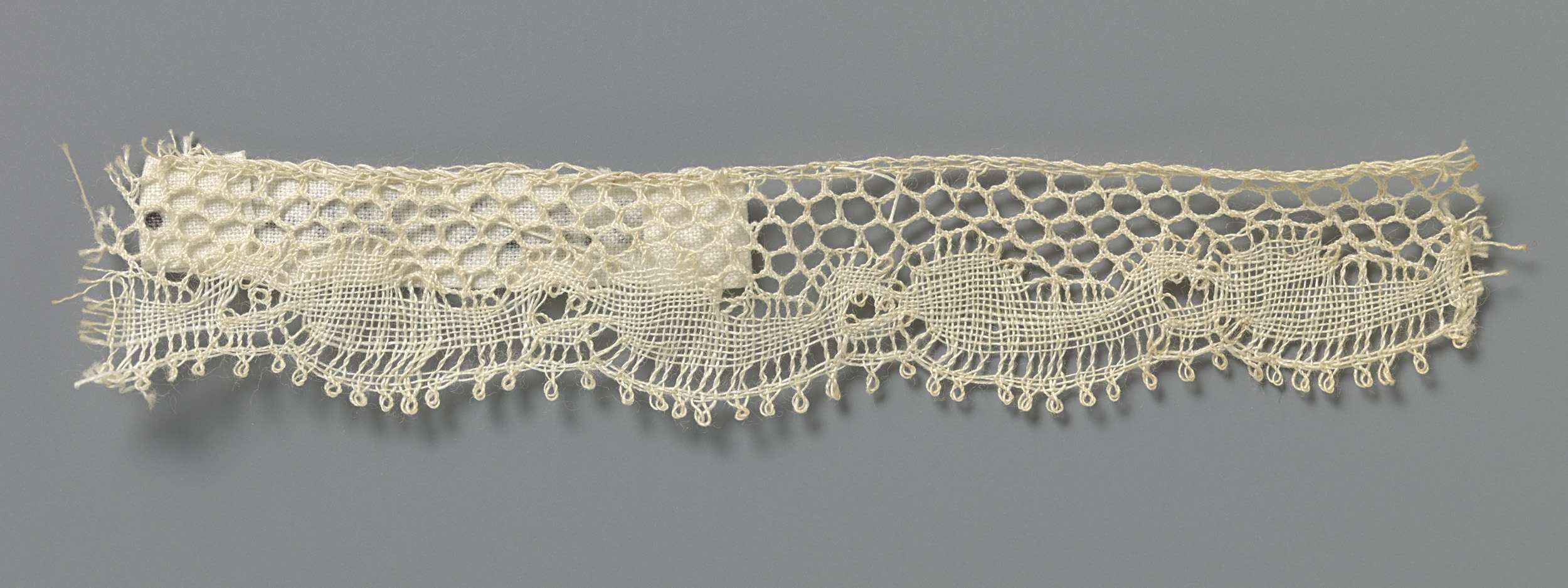 Textile artwork of lace featuring intricate circles and commas by Unknown Artist
