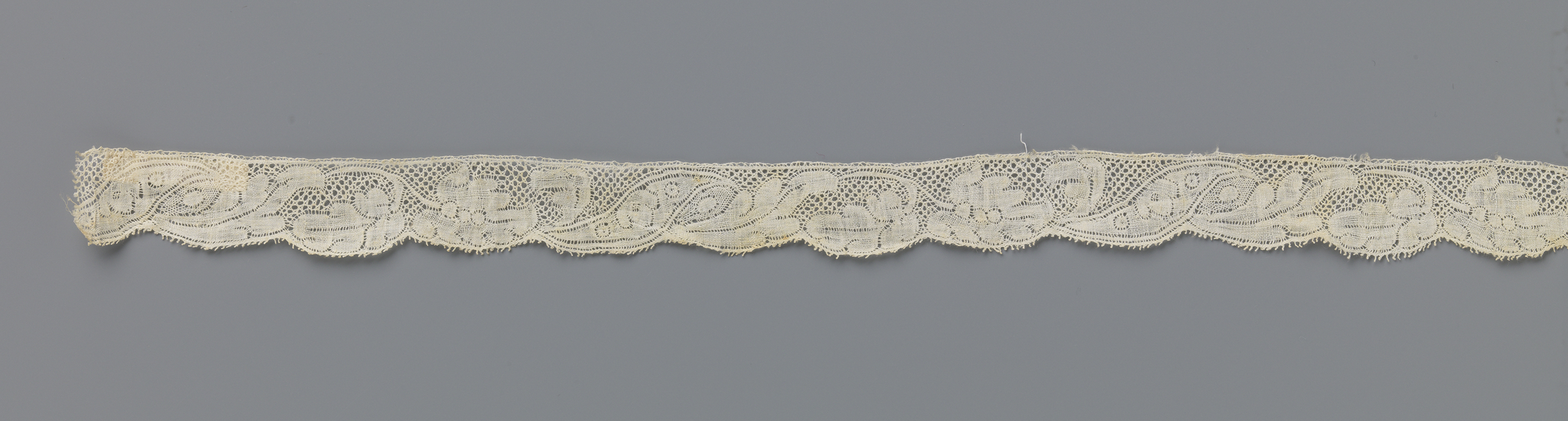 Lace artwork by unknown artist featuring a plume-shaped flower.
