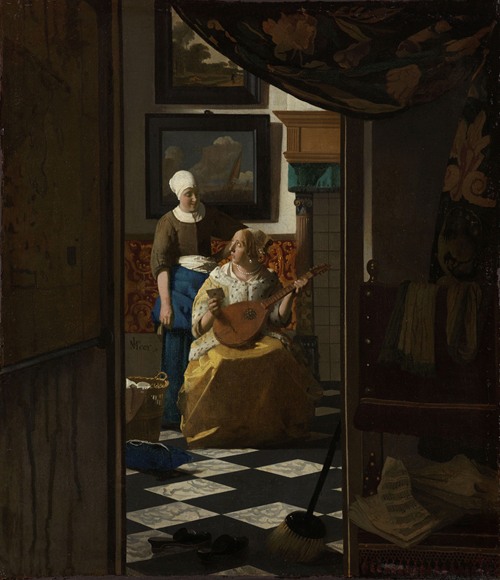A woman reading a letter in a domestic interior.