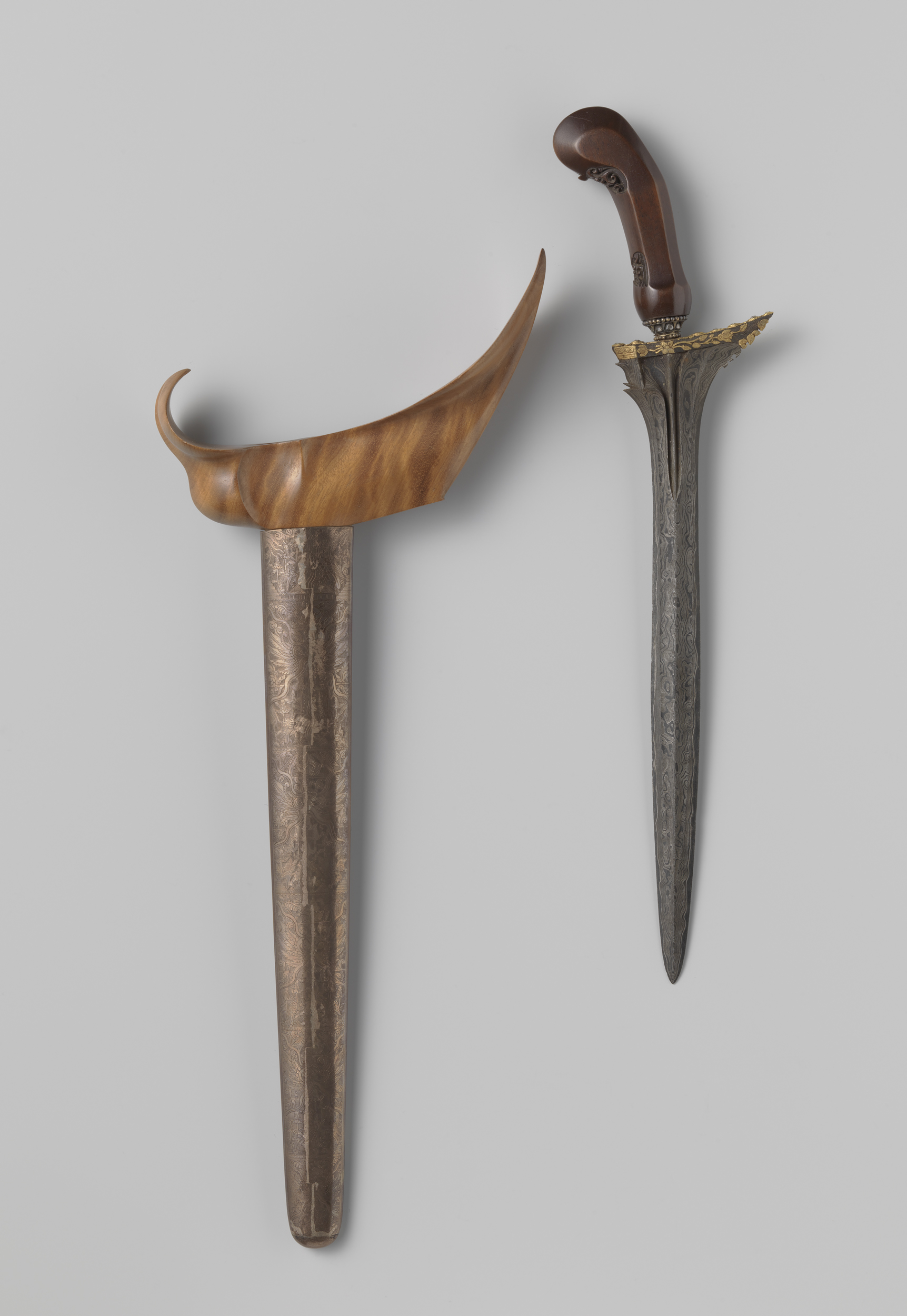Javaanse kris, a metalwork piece by Unknown Artist featuring intricate hilt patterns.