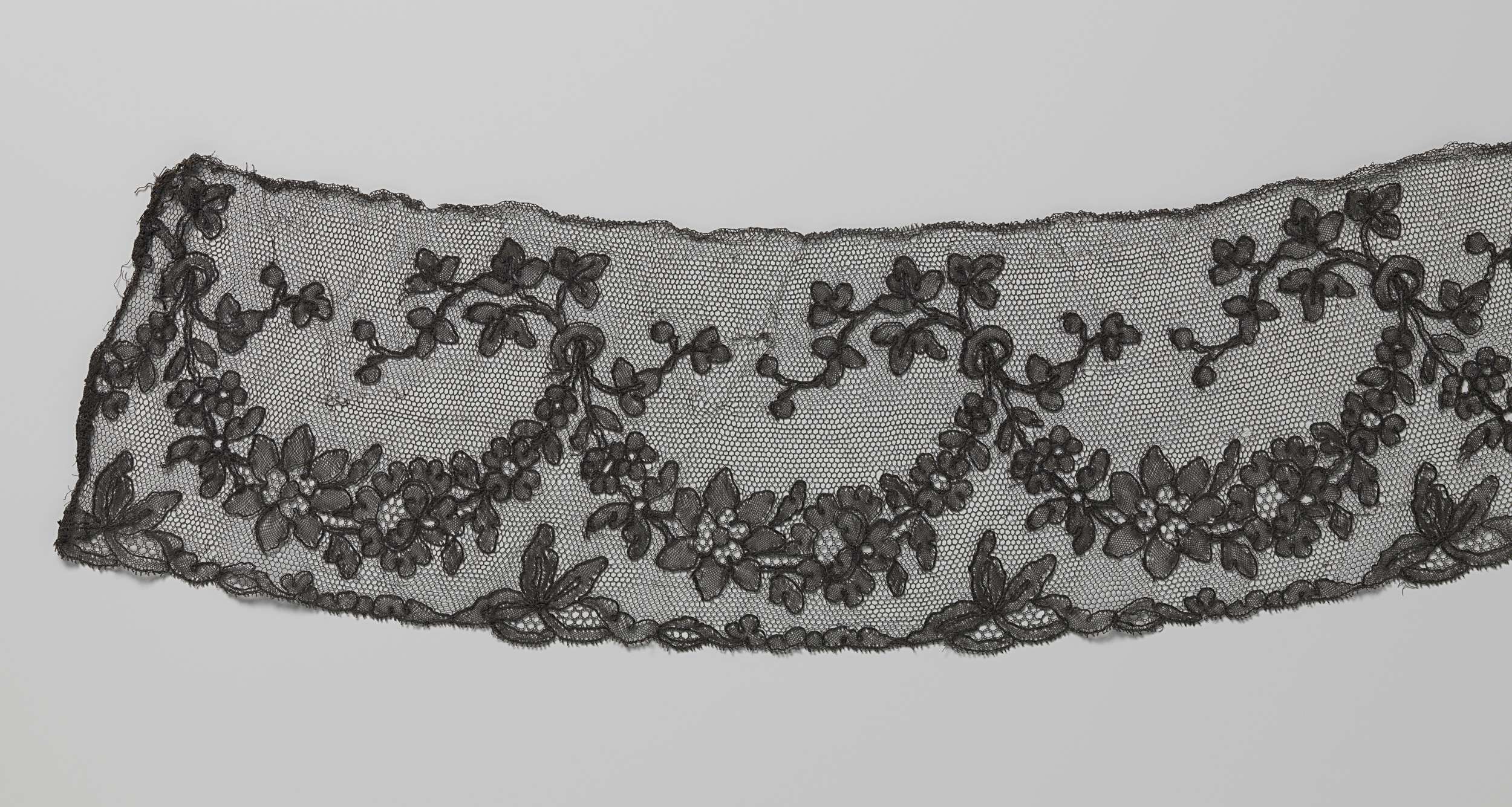 Lace artwork by Unknown Artist depicting a female figure adorned with garlands and ribbons.