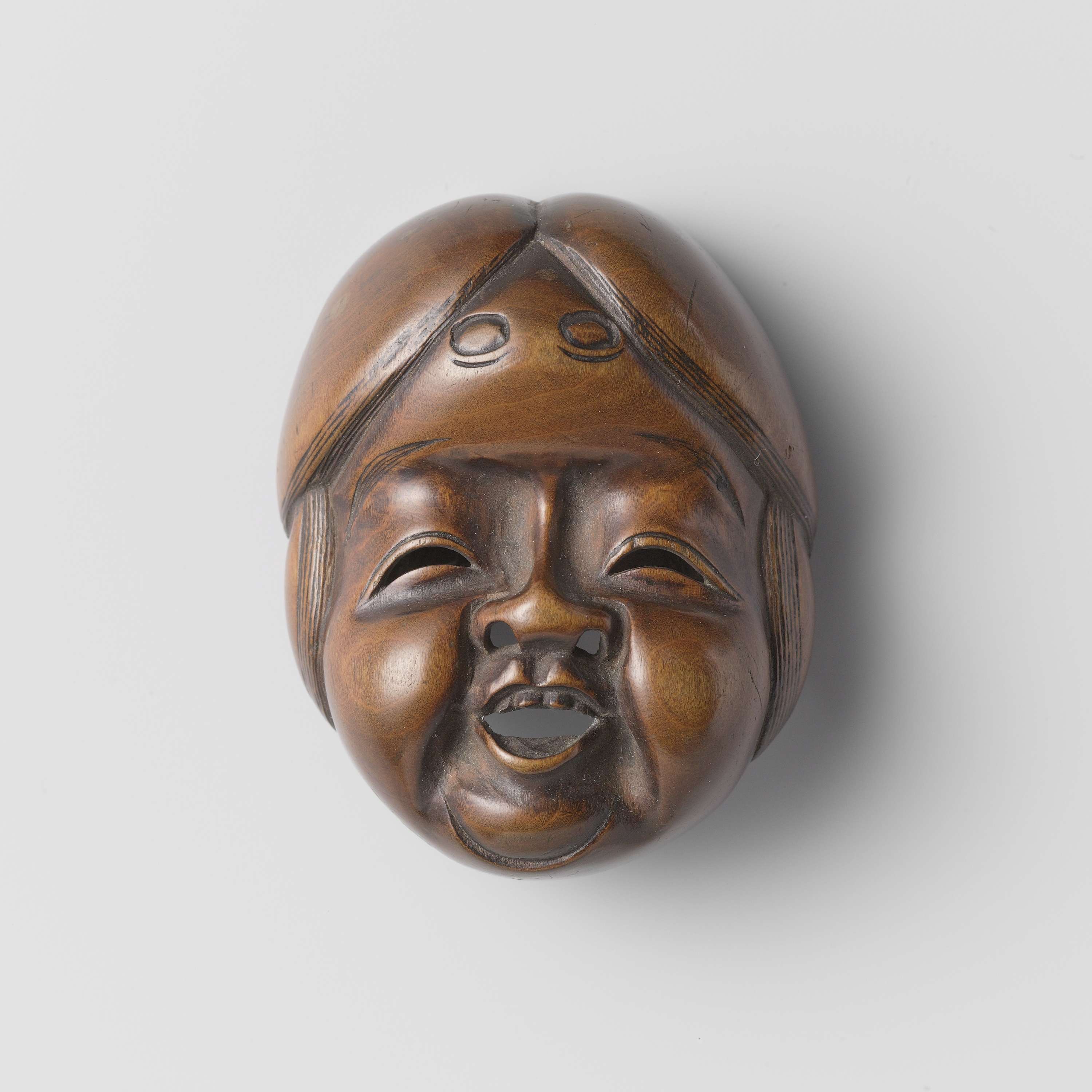 Netsuke wood sculpture by Shuzan with intricate details and craftsmanship