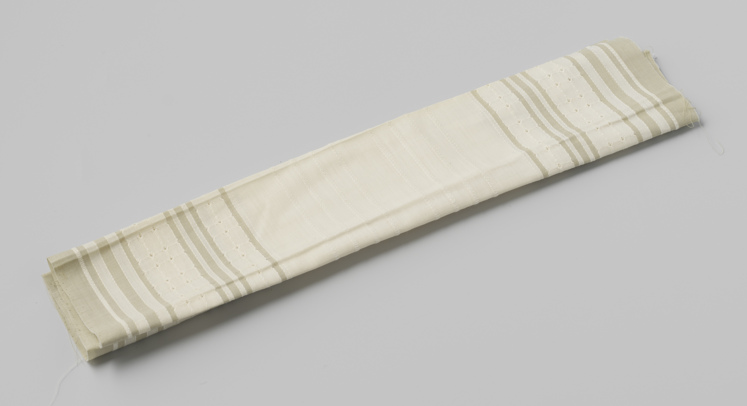 Textile work by Gustav Schnitzler featuring grey and green striped patterns.