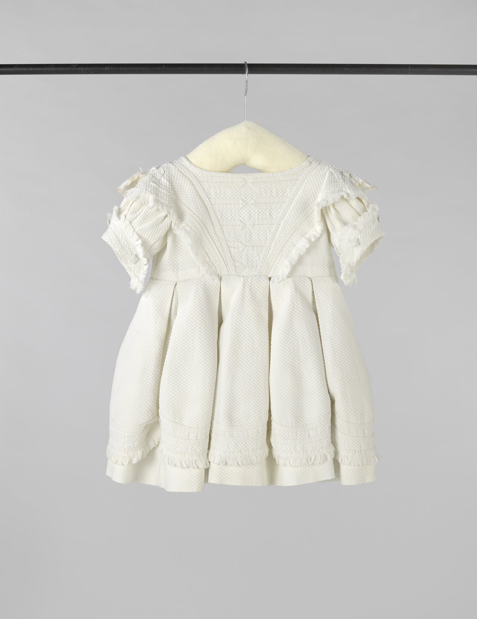 Victorian textile garment by unknown artist, featuring intricate white piqué and puffed sleeves