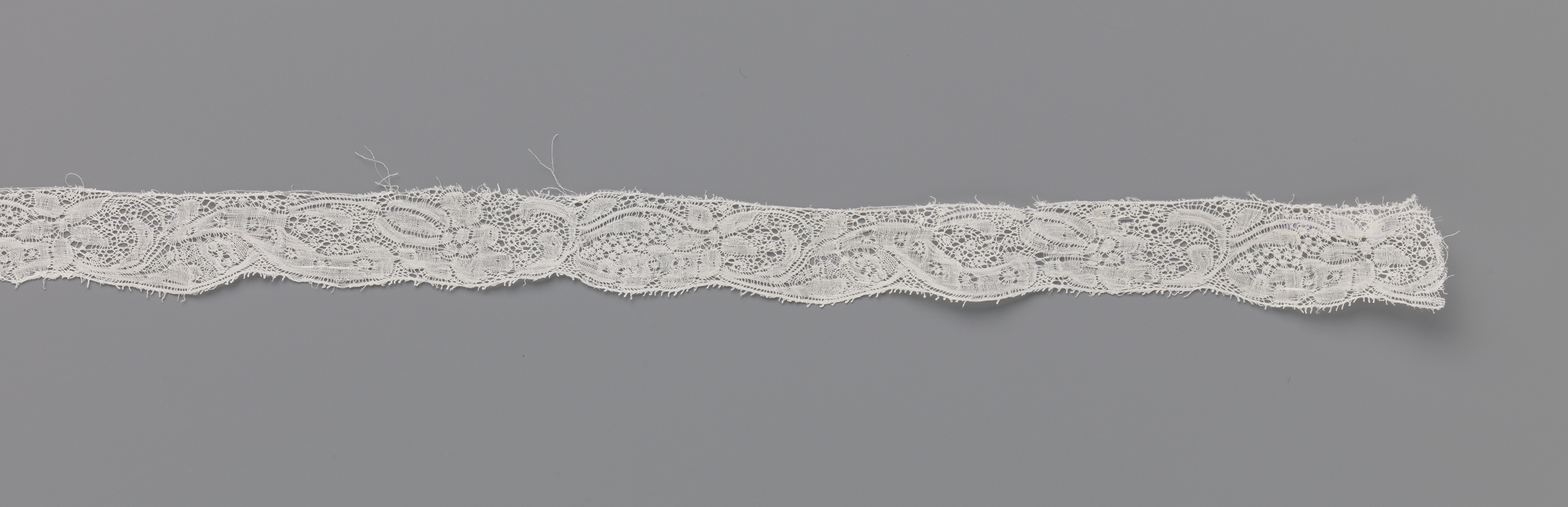 Lace artwork by Unknown Artist featuring plum-shaped and star-shaped flowers