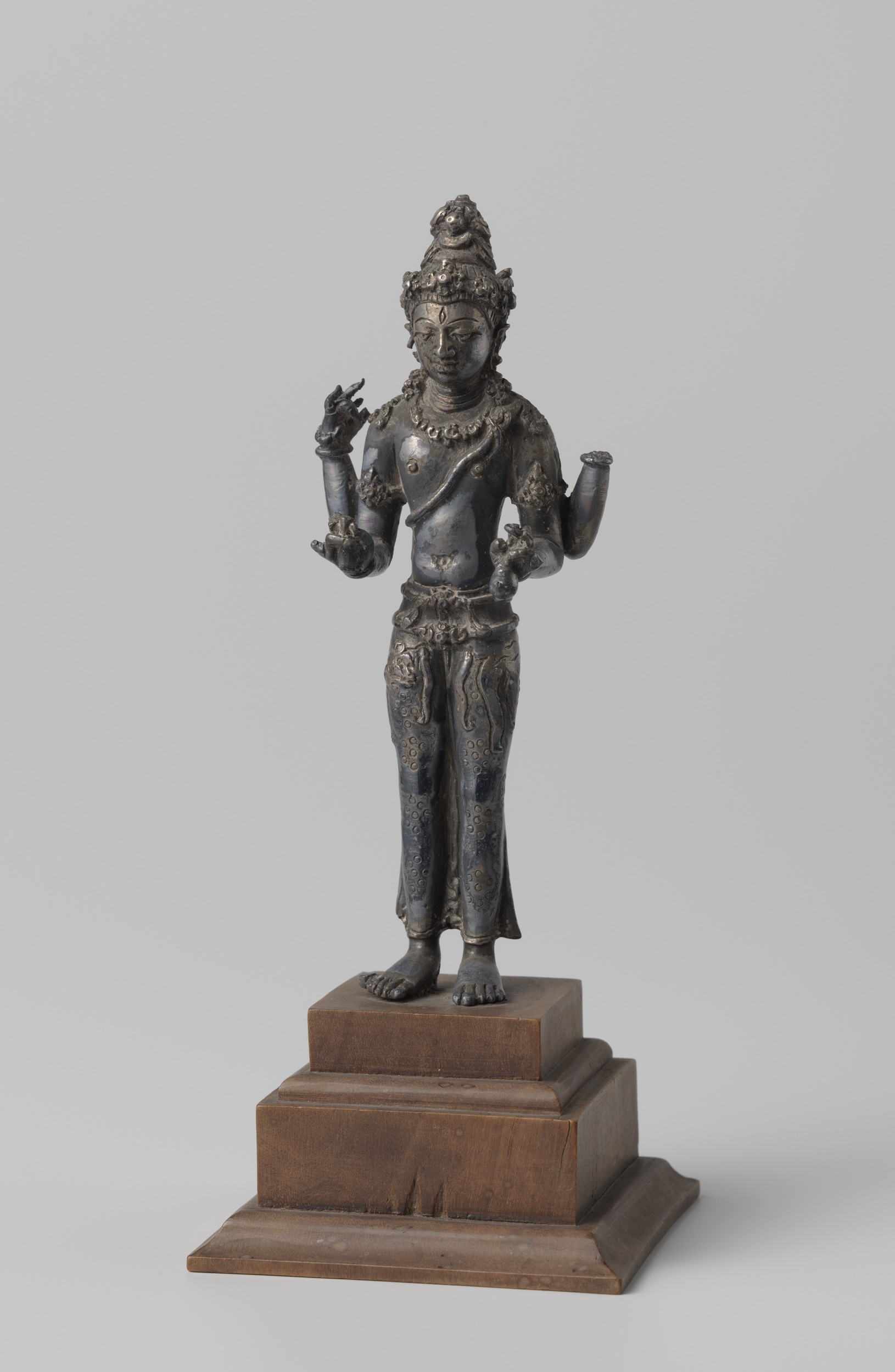 Shiva sculpture in metal by unknown artist, holding sacred water and prayer beads.