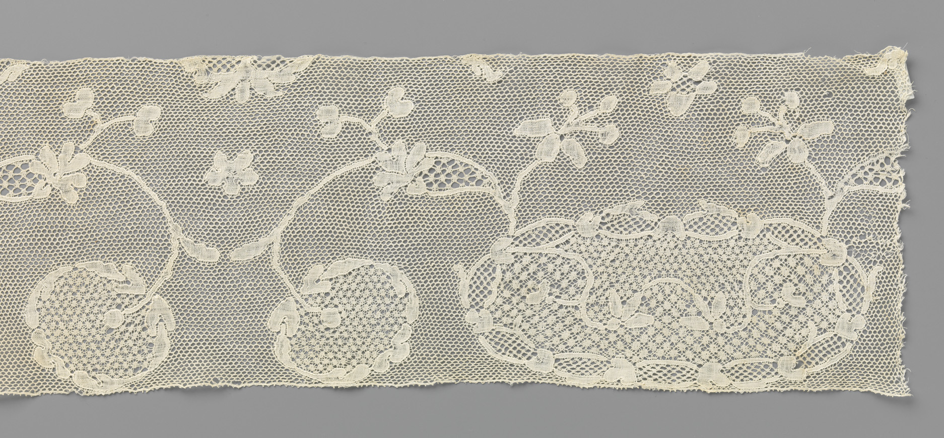 Lace piece featuring an oval cartouche and floral motifs by Unknown Artist