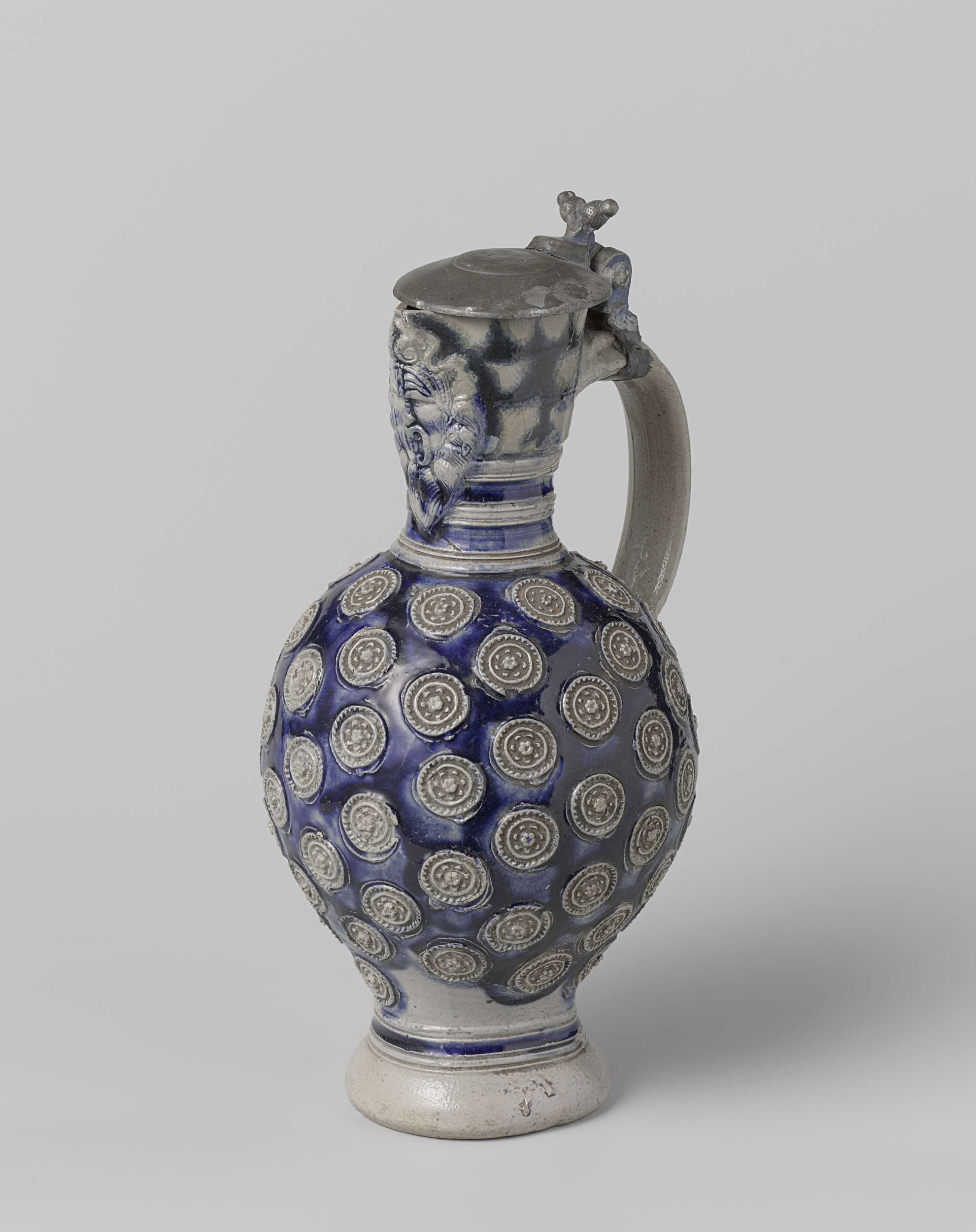 Ceramic jug featuring a mask and medallions by an unknown artist