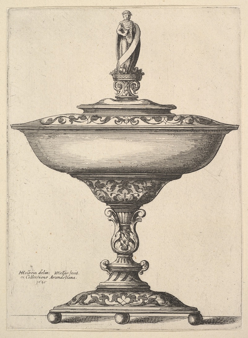 A wide cup with ball feet, intricately designed, showcasing fine craftsmanship.