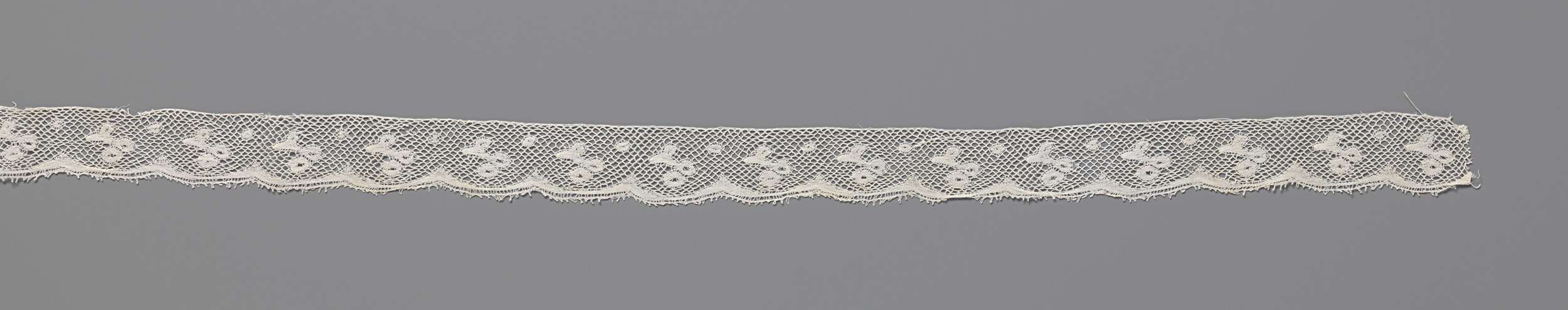 Lace artwork by Unknown Artist featuring a twig with two berries