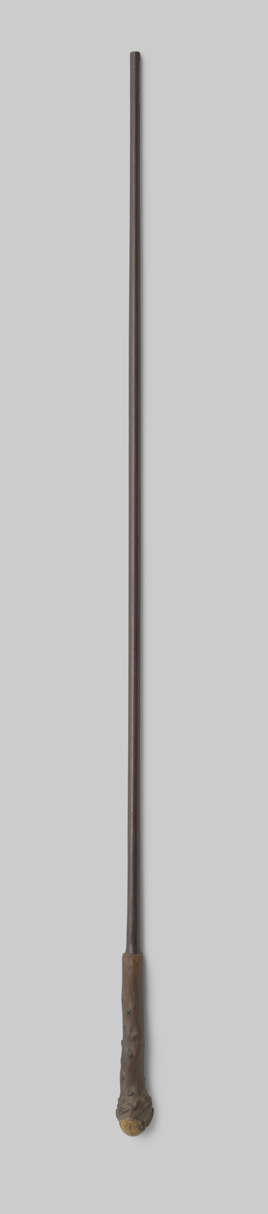 Wood decorative art by Gustav Schnitzler featuring a knotted umbrella handle