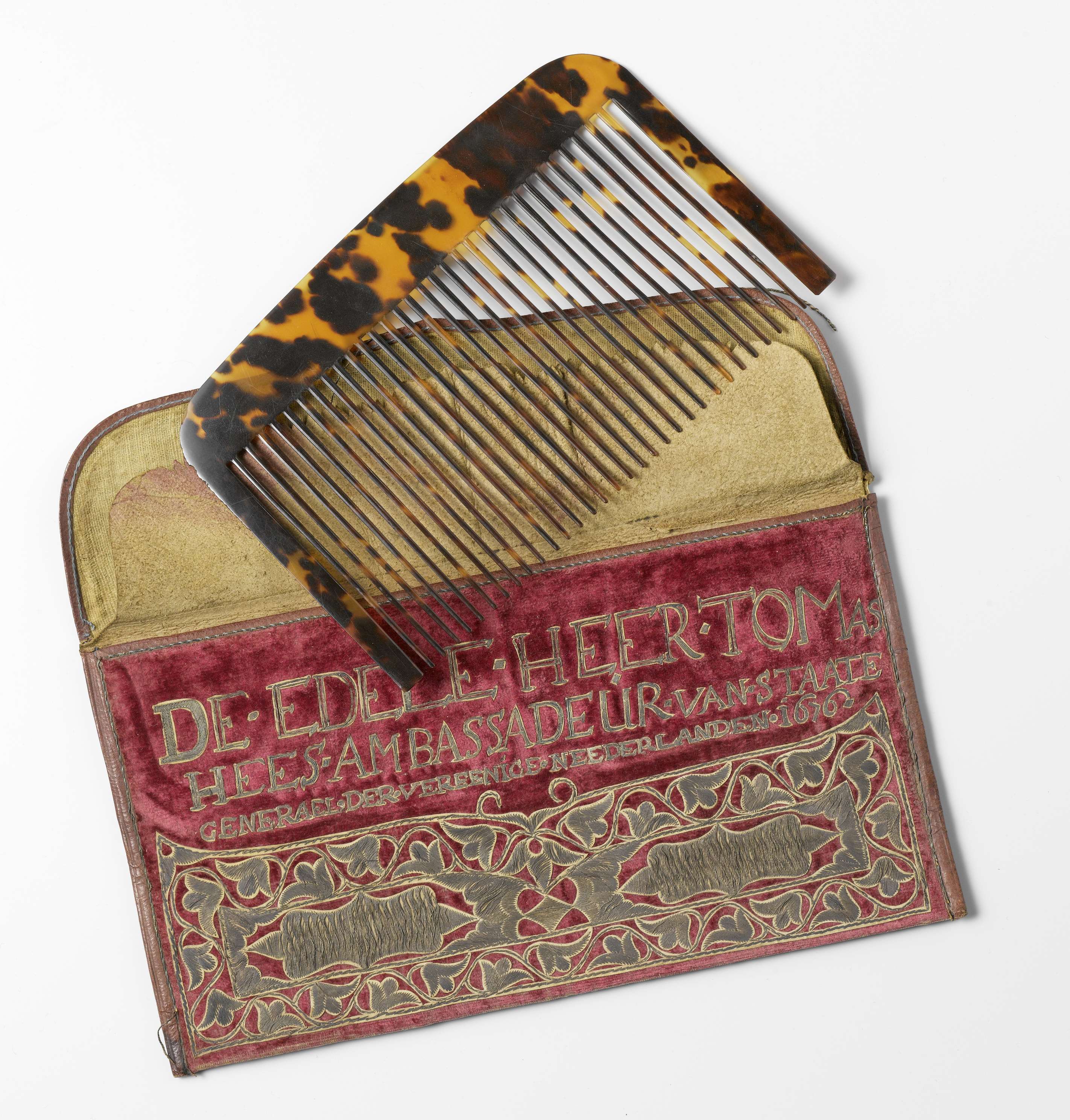 Textile artwork by unknown artist featuring a letter case and comb