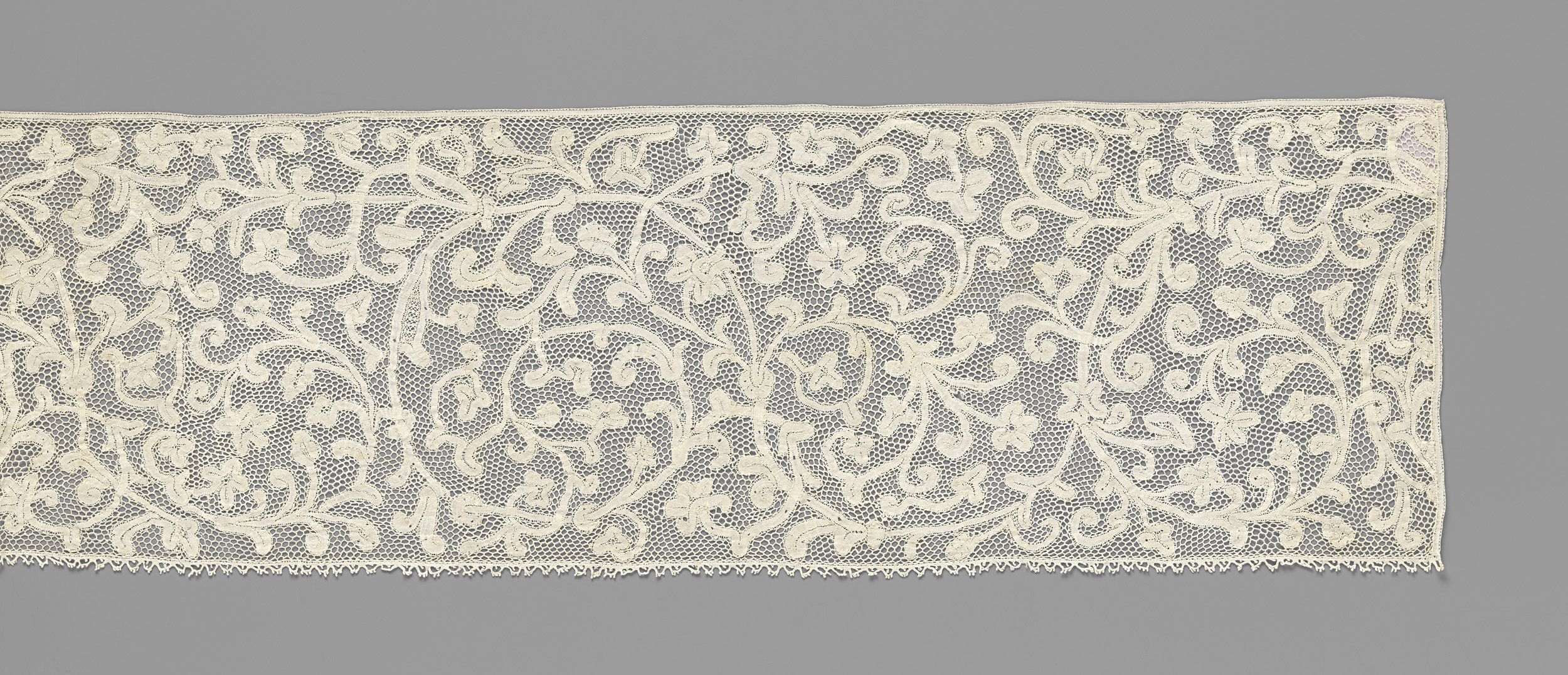 Lace artwork by Unknown Artist featuring intricate floral patterns and ribbons.