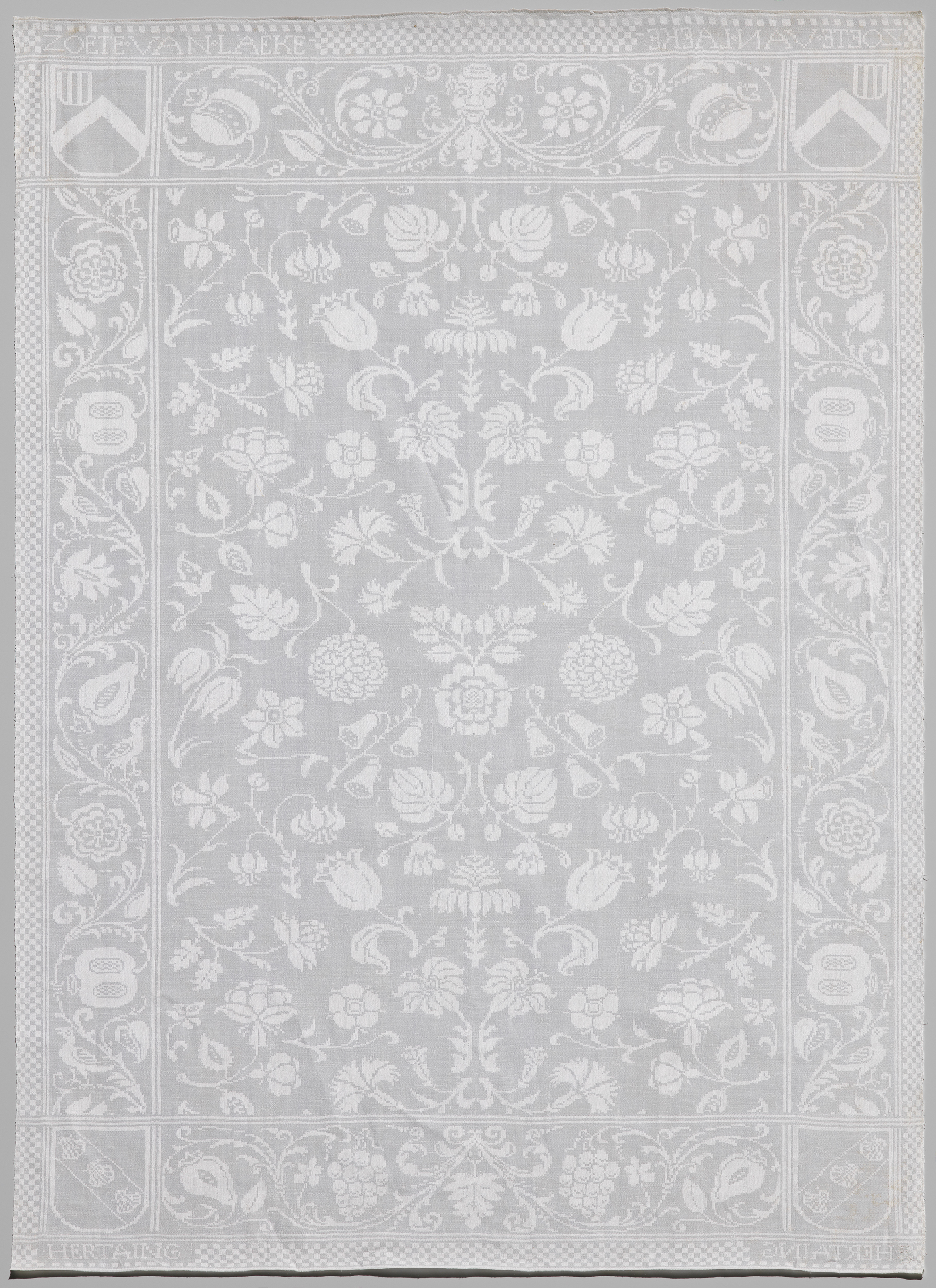 Decorative linen with floral patterns and woven names by unknown