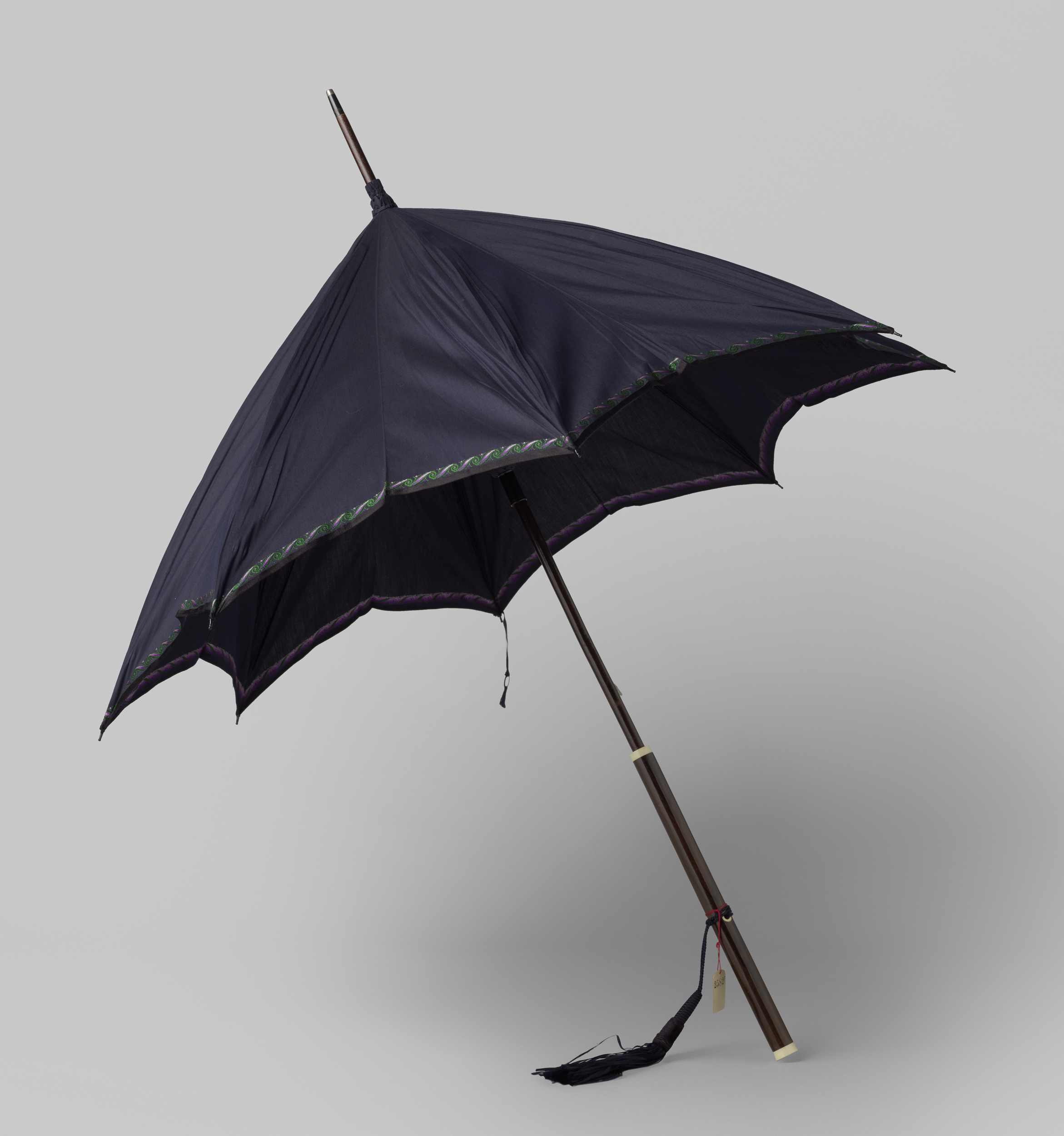 Still life of an umbrella made of blue silk and purple trim by Gustav Schnitzler