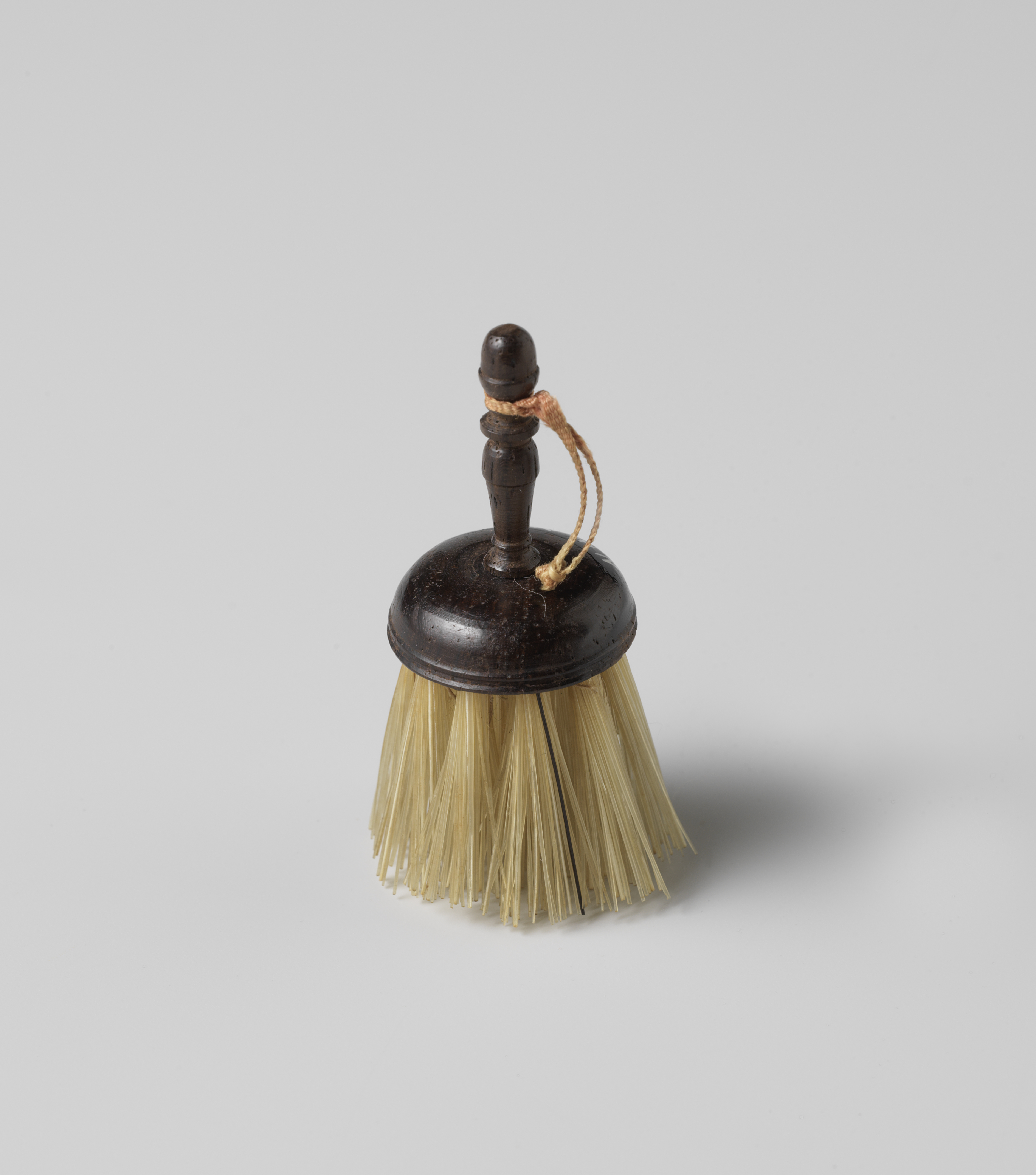 Wood brush with round head and pink ribbon by Unknown Artist