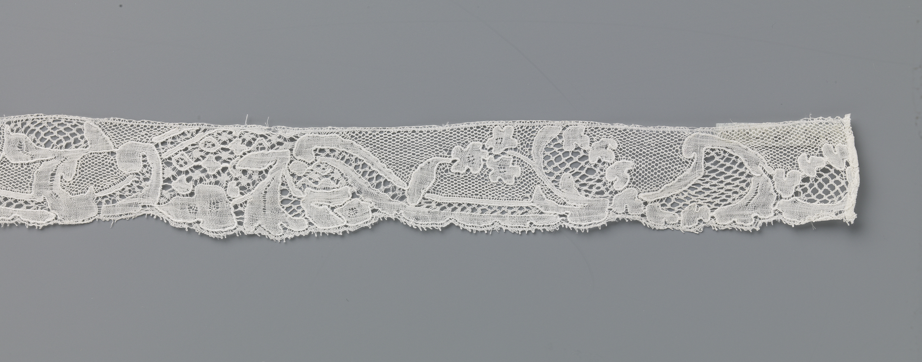 Intricate lace textile with overlapping leaf motifs by Unknown Artist