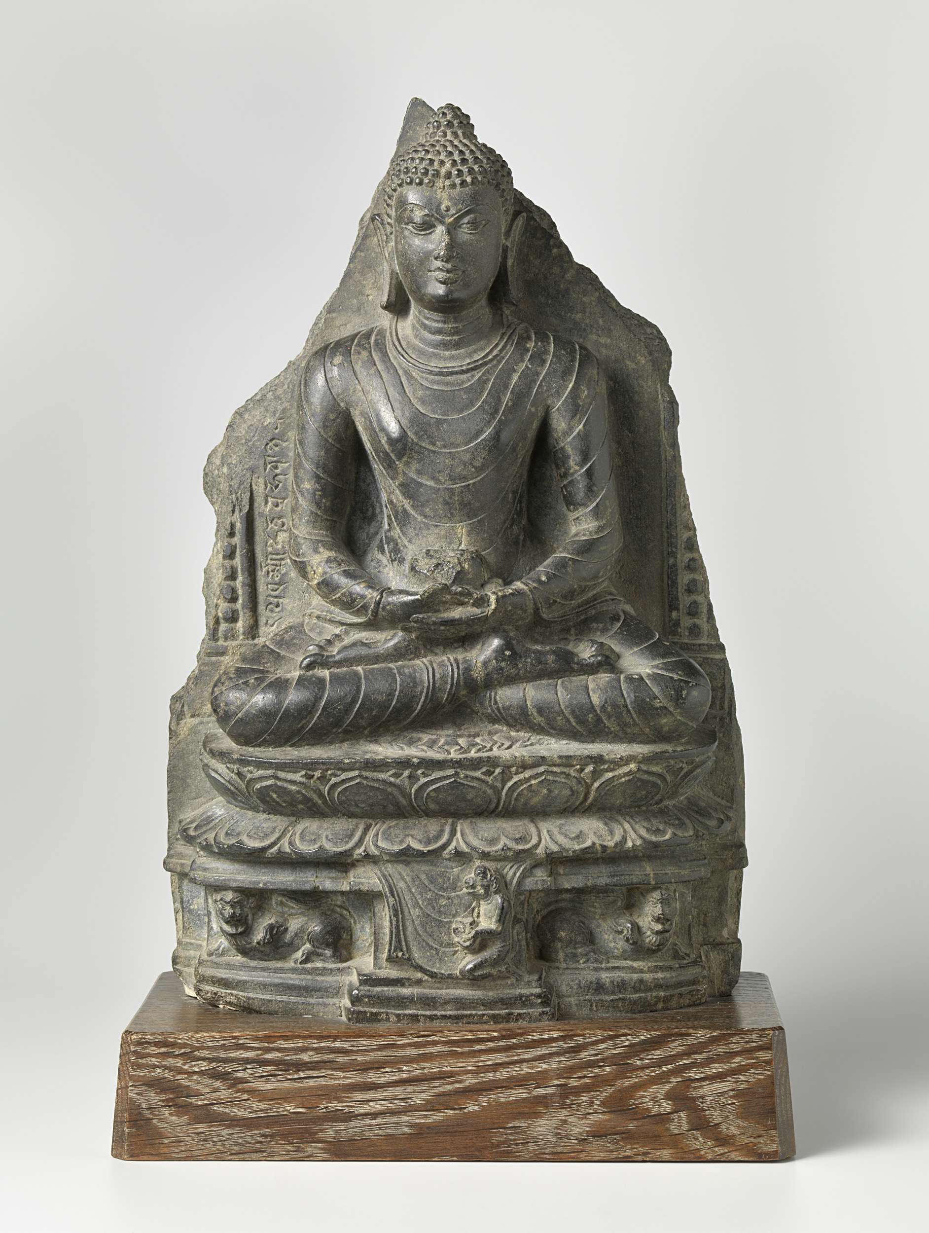 Stone sculpture of Buddha by unknown artist, depicting serenity and meditation.