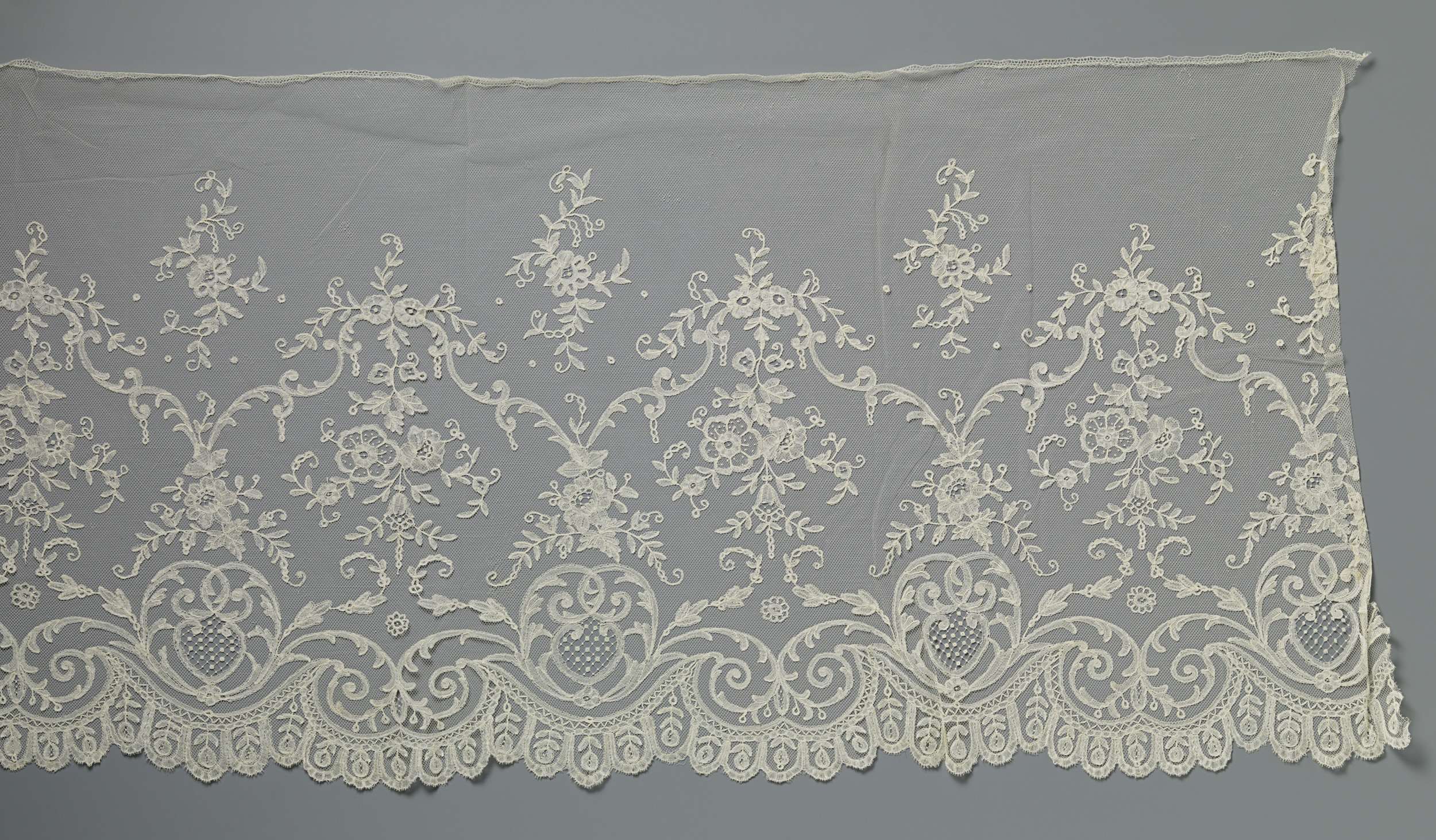 Intricate lace textile by Unknown Artist featuring curved gate arches.