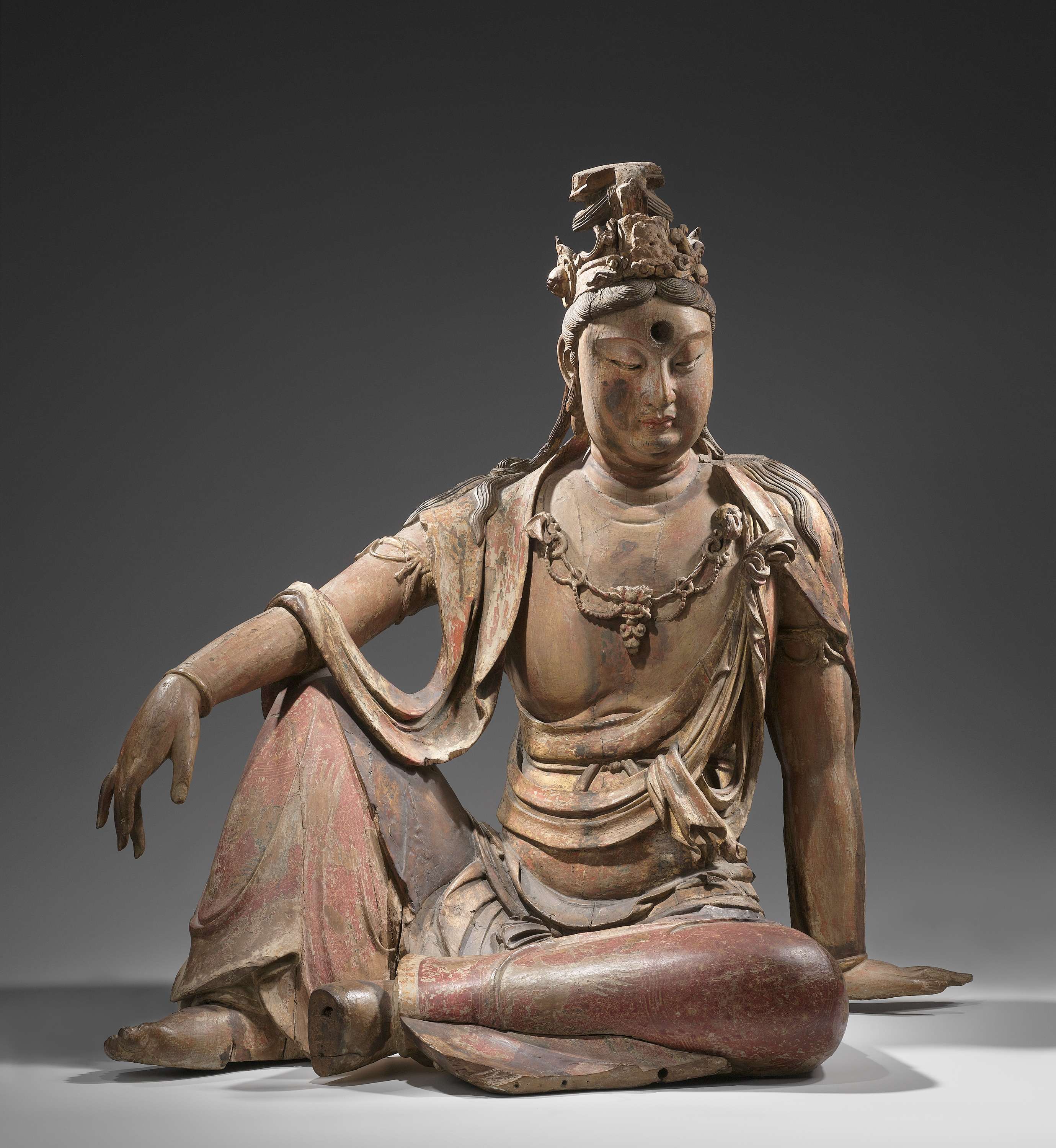 Wood sculpture of Guanyin meditating on a rock, unknown artist