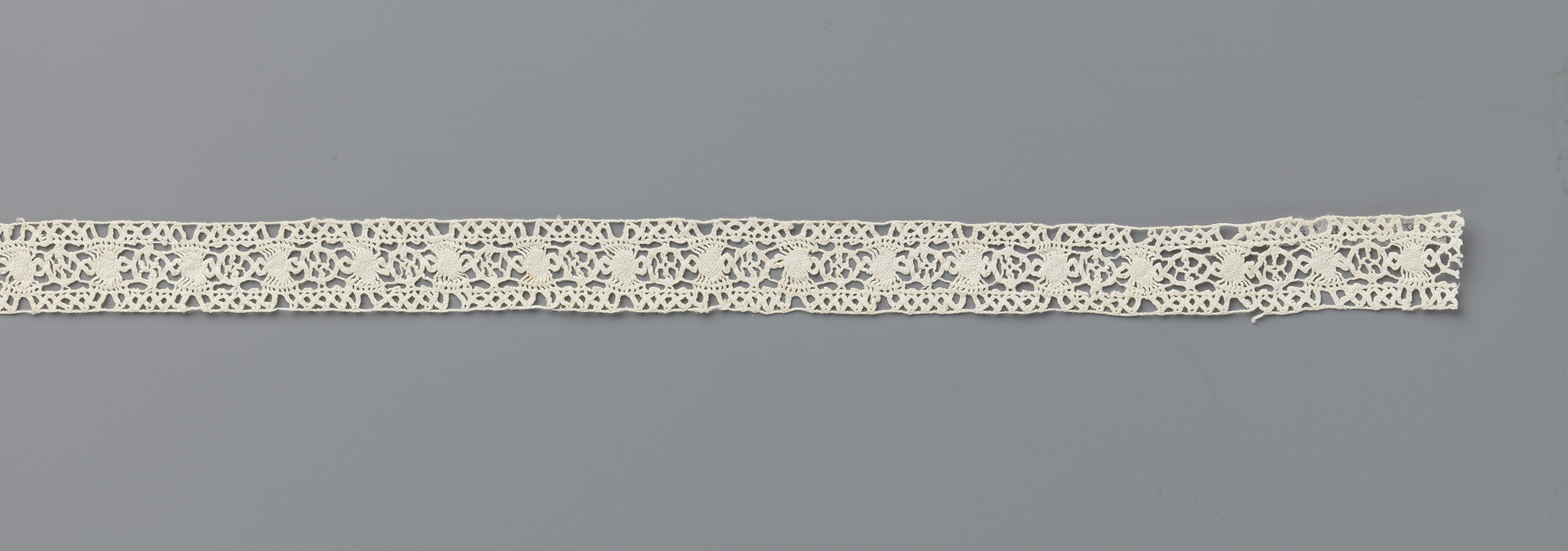Intricate lacework featuring wheels and sunbursts by Unknown Artist