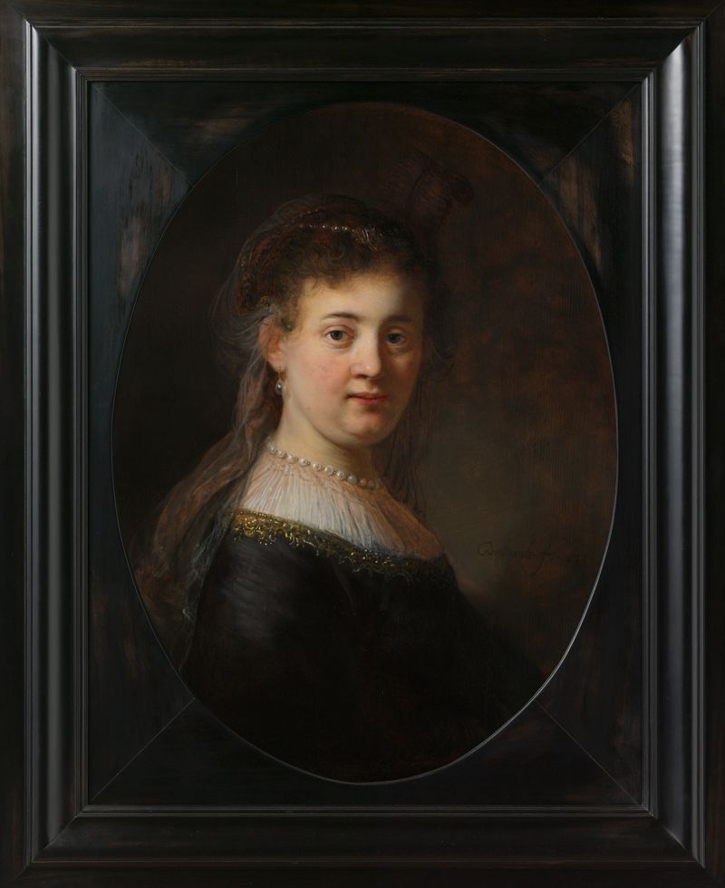 Joven mujer en disfraz de fantasía, óleo sobre panel de Rembrandt van Rijn