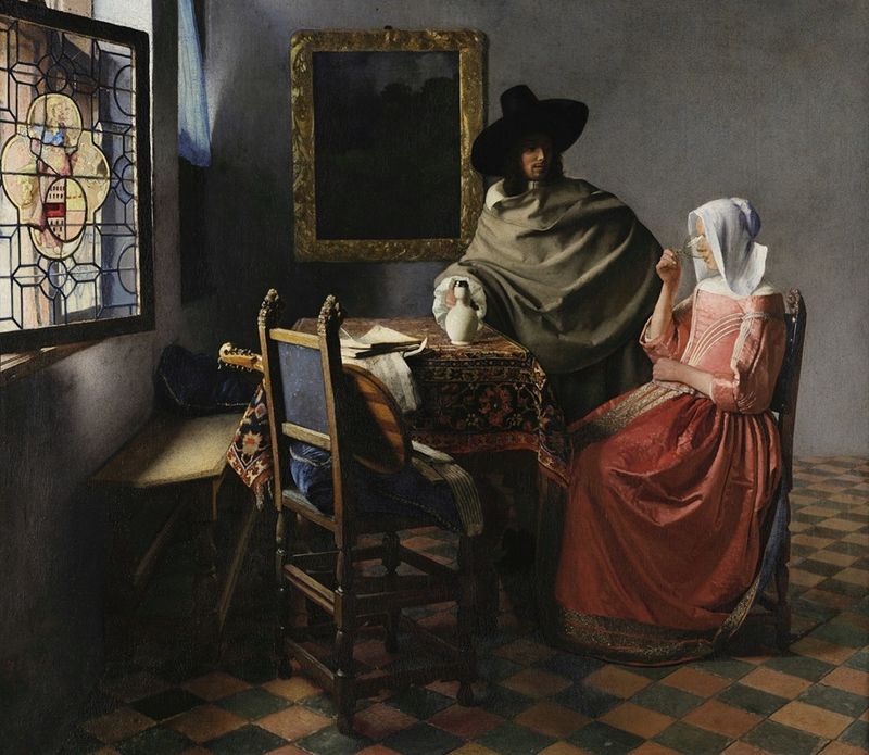 The Wine Glass by Johannes Vermeer, oil on canvas, depicting a woman lifting a glass in an interior.