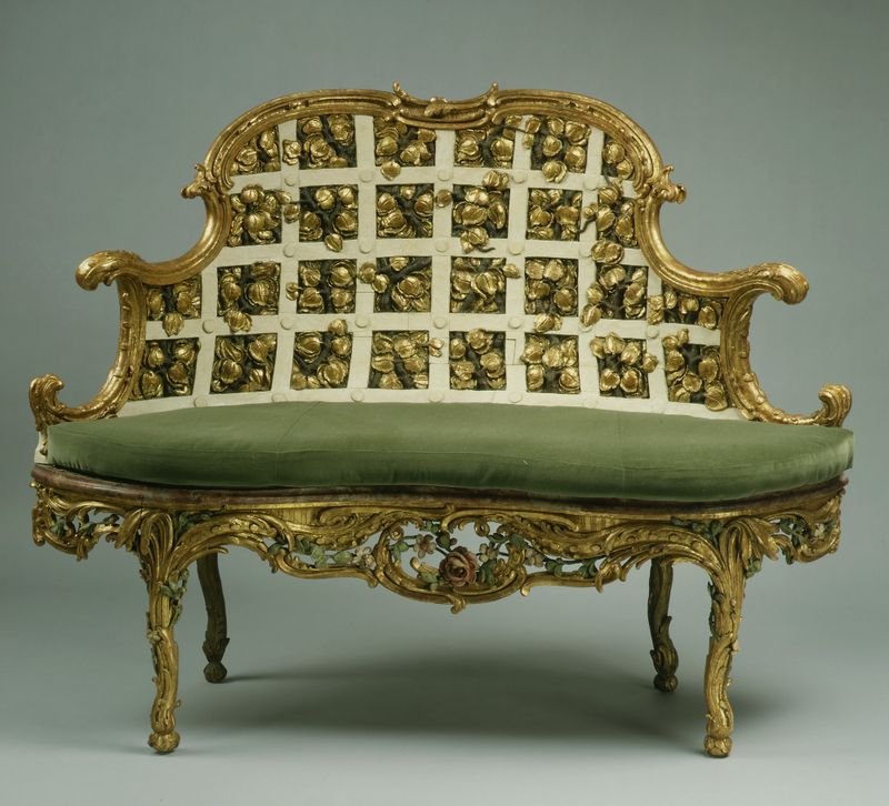 Settee by Johann Michael Bauer, wood medium, featuring intricate carvings in Rococo style.
