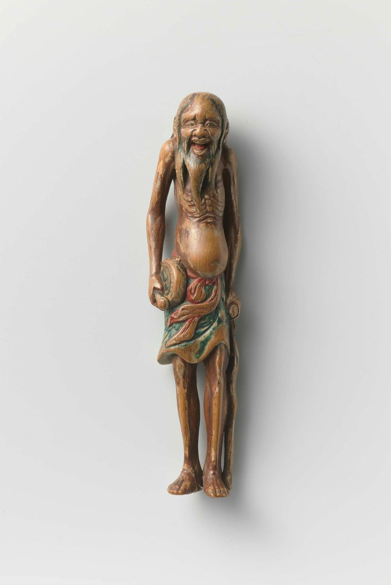 Netsuke de um homem santo com um tambor e um bastão, madeira, artista desconhecido