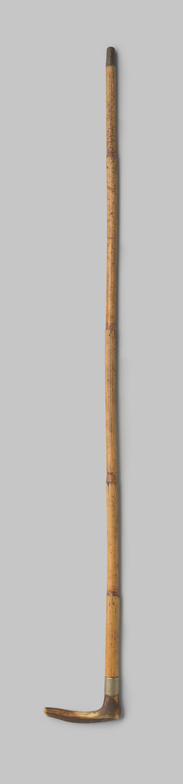 Decorative art piece by Gustav Schnitzler featuring a bamboo umbrella and copper details