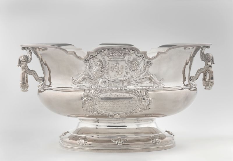 Wine fountain and cooler in metal by Alger Mensma, showcasing decorative elements and naval motifs.