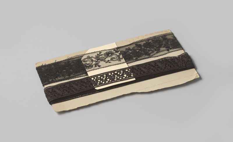 Tecido decorativo de Gustav Schnitzler com motivos florais e de folhas em renda preta.