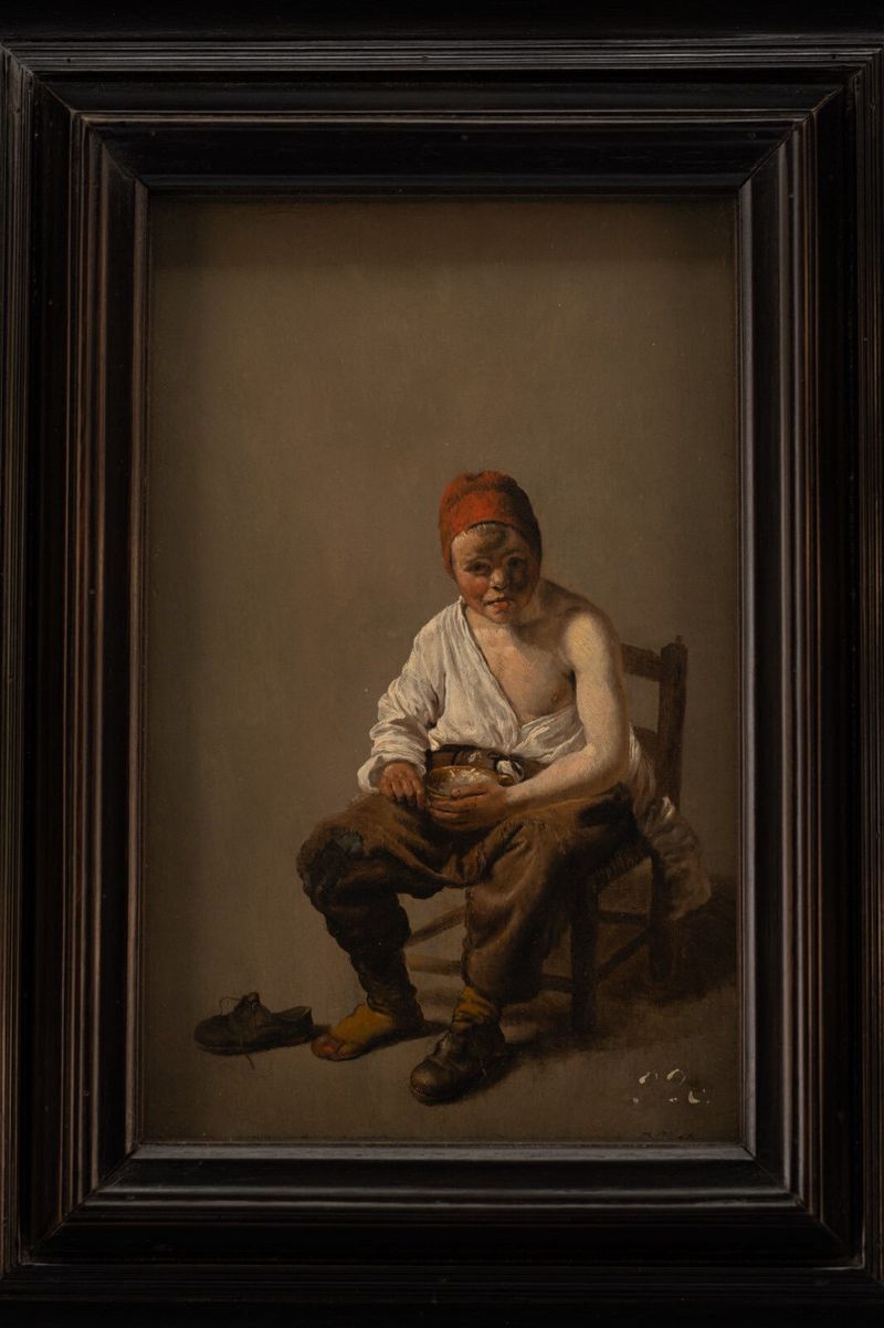 Seated Boy Eating Porridge, óleo sobre panel de Pieter Jacobsz. Duyfhuysen