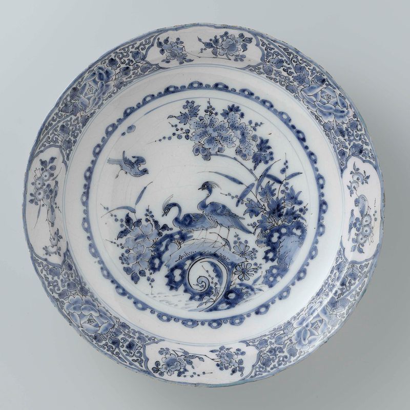 Earthenware dish by Het Moriaanshooft reflecting light and surroundings.