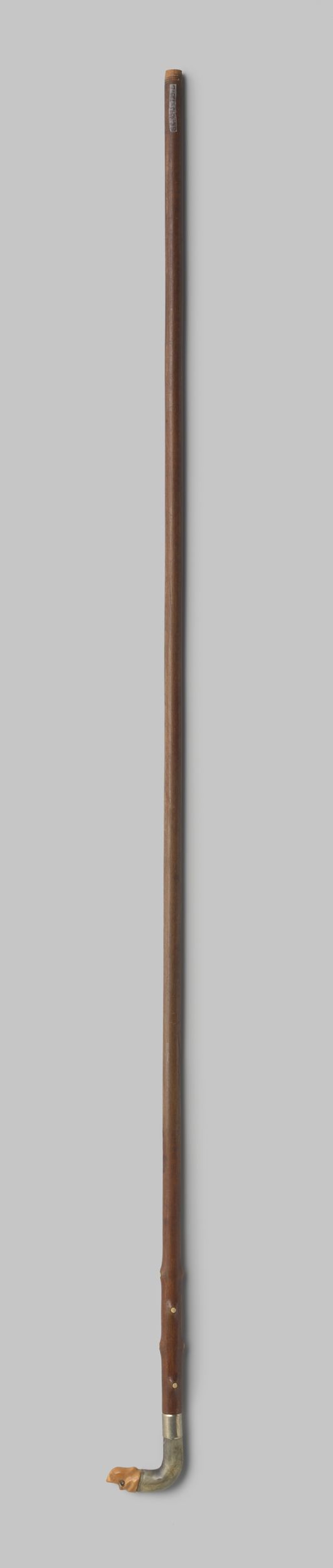 Decorative art piece by Gustav Schnitzler, featuring a horn and metal parasol handle.
