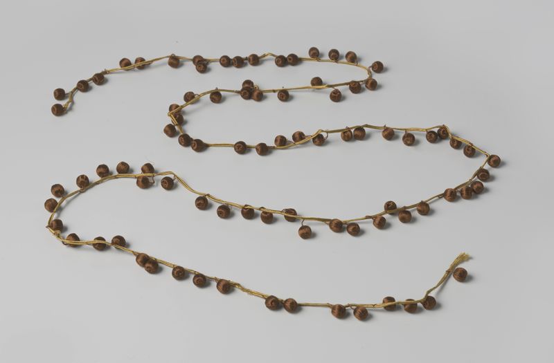 Decorative art by Gustav Schnitzler featuring golden galon with brown silk pompons.